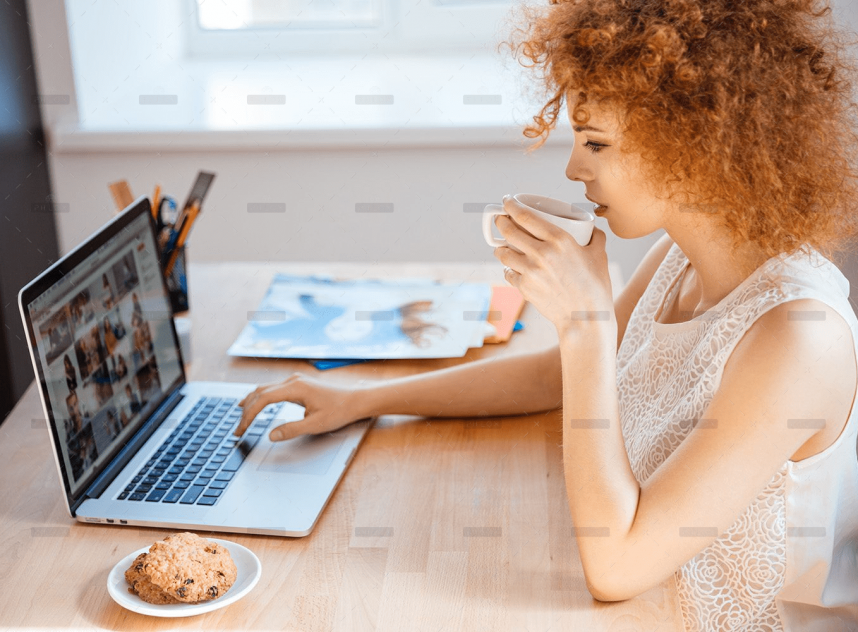 demo-attachment-493-woman-photographer-drinking-coffee-and-working-PJNBP6U